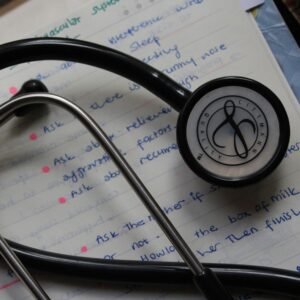 A black stethoscope on handwritten medical notes enhances a study session.